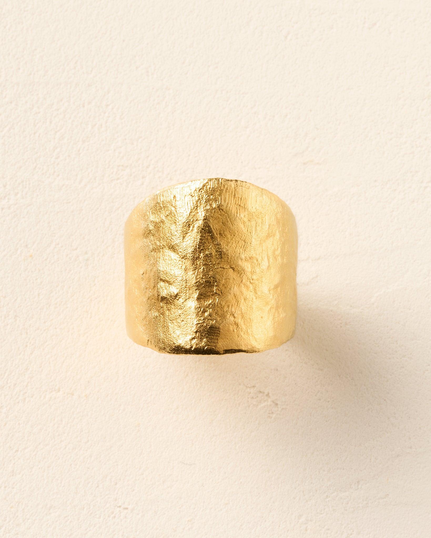 Lunaïs Ring: Wide, textured golden band with an organic, hammered finish.