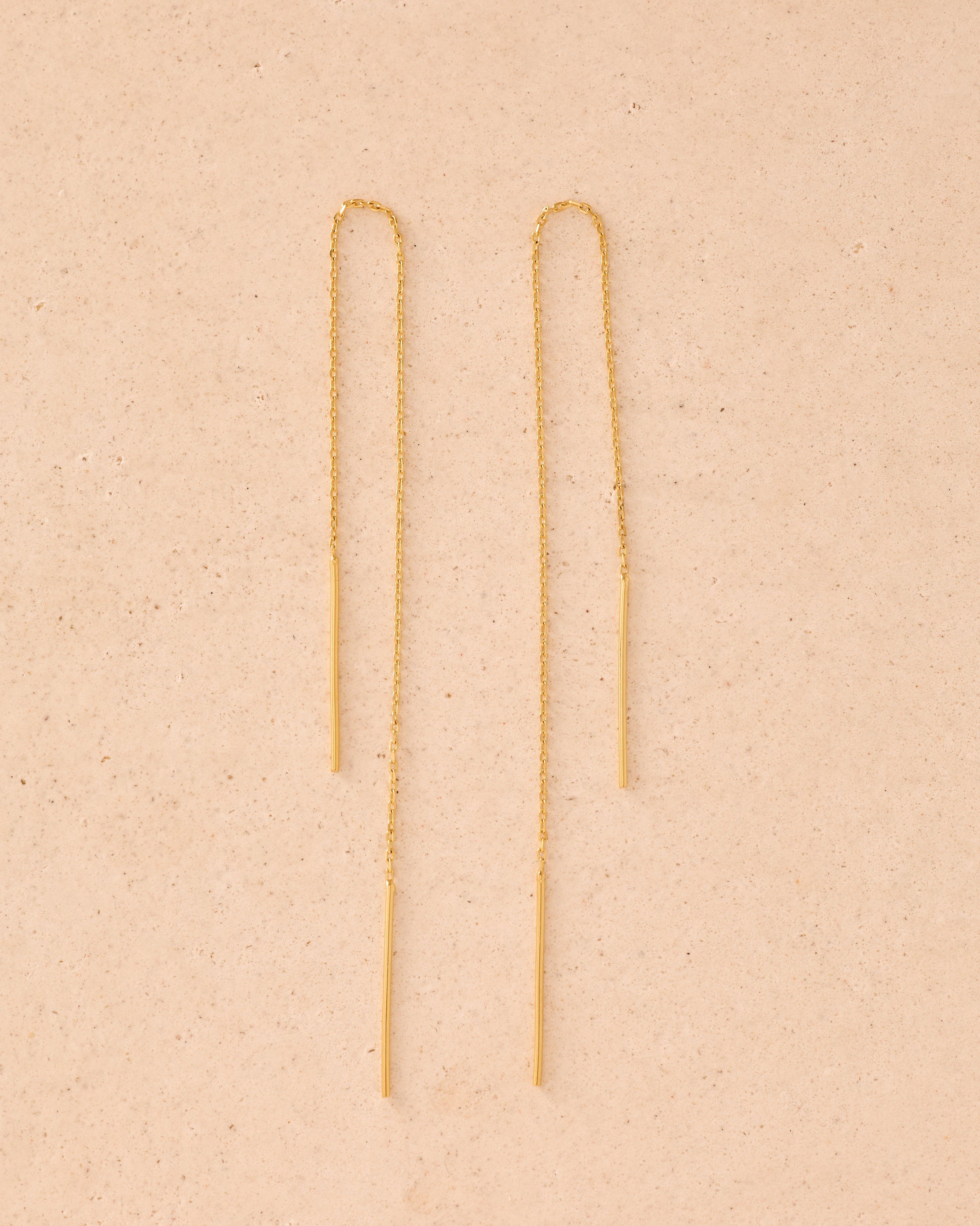 Pair of long, delicate gold threader earrings with thin bar drops.