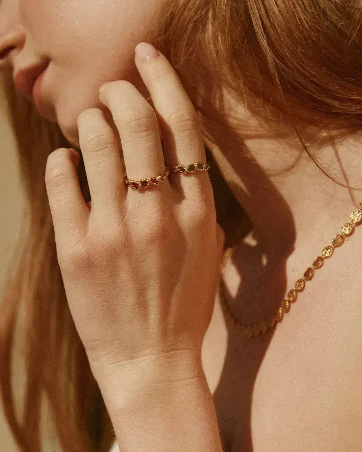 Koré green slim cluster ring with five dark green stones organically set in gold.