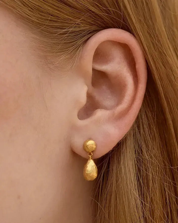 Dalias gold-toned hammered drop earrings with a small stud and larger teardrop shape.
