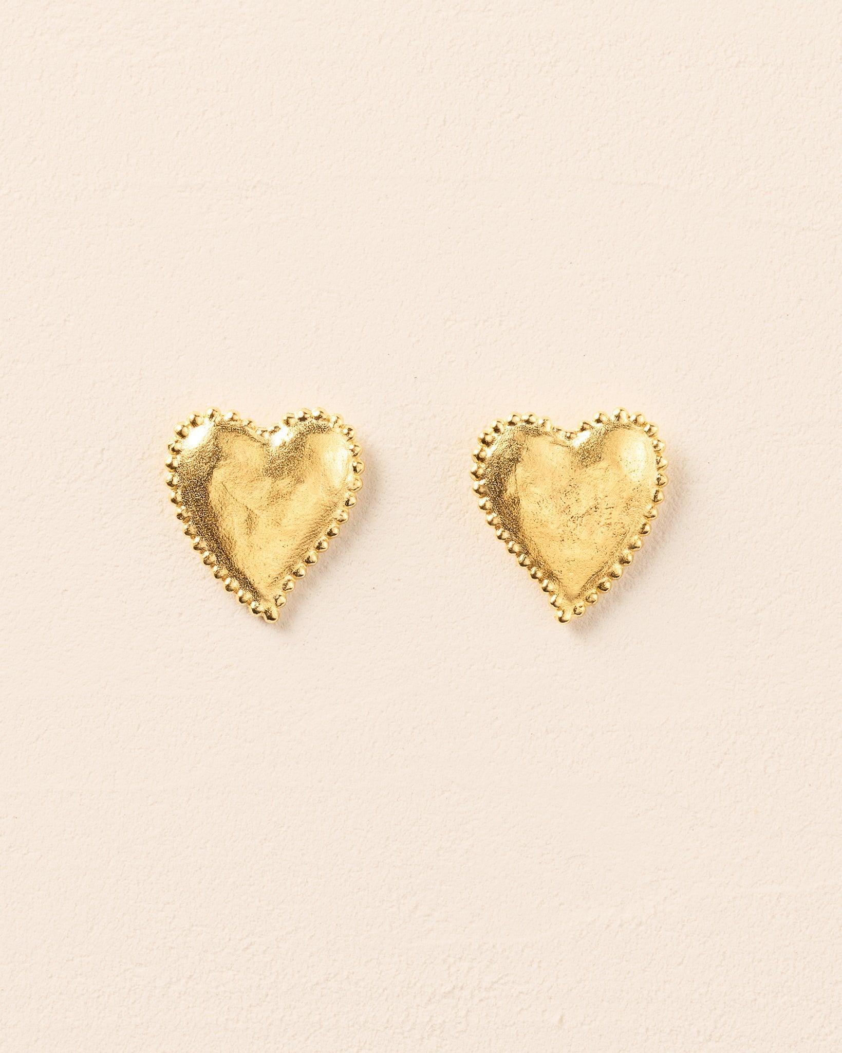 Gold Amori heart earrings with hammered texture and beaded halo.