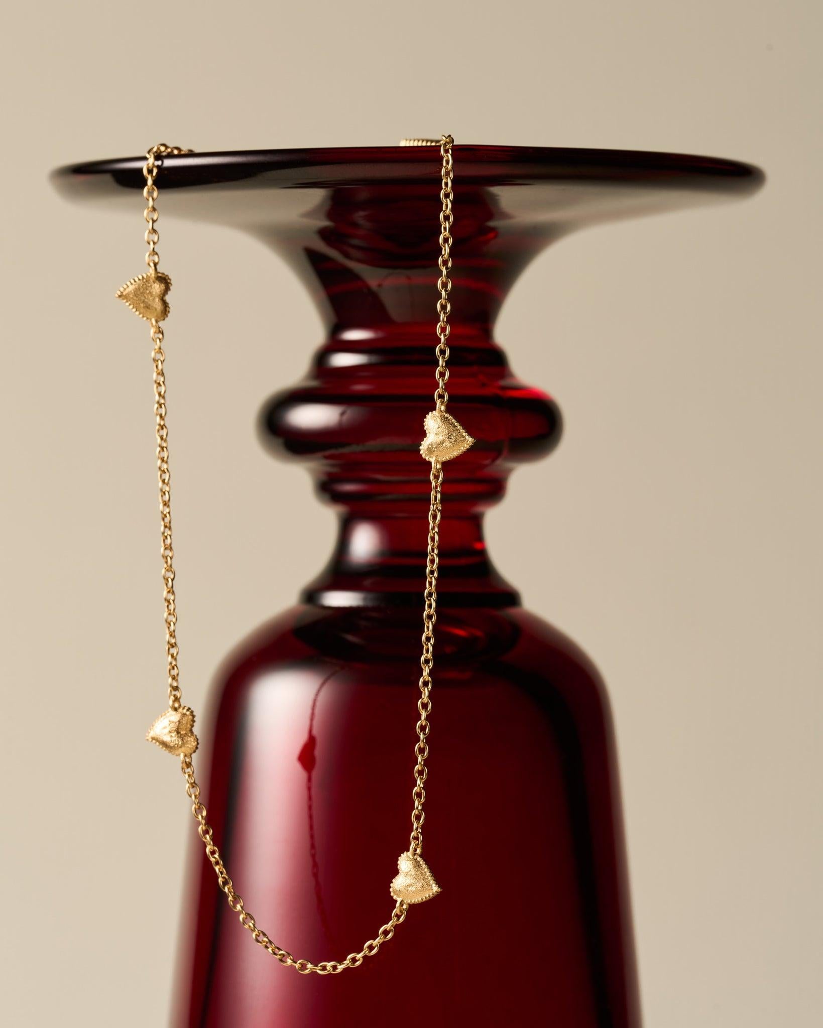 Amori Choker: Golden chain necklace with small, hammered heart charms and beaded halo detail.