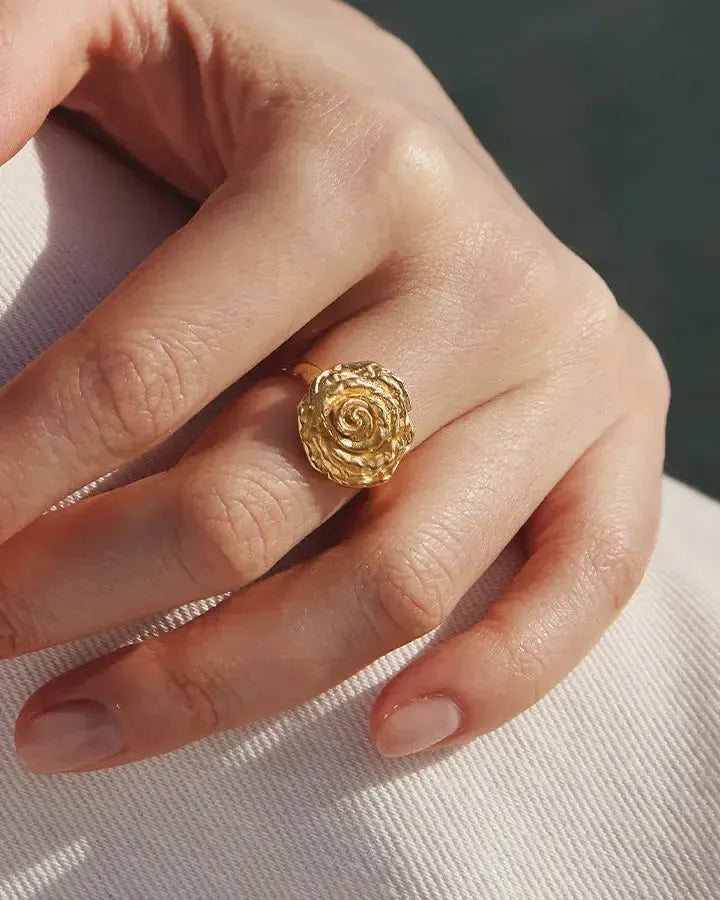 Gold Rosie Ring with voluminous, hammered rose petals on a hand.