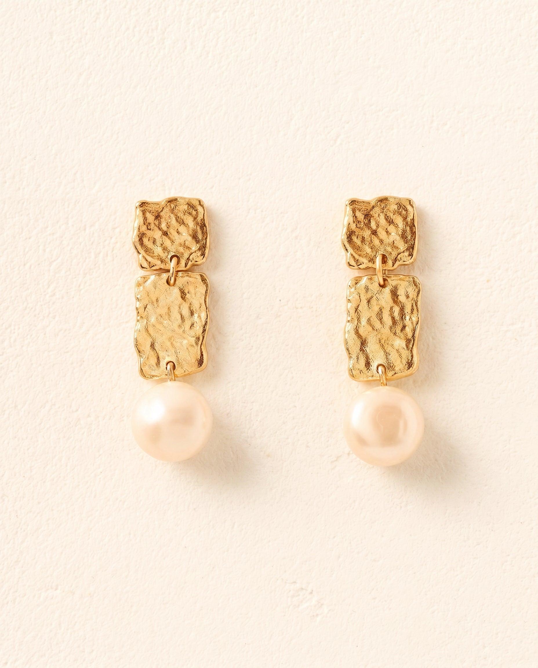 Gold Lythos drop earrings with textured, hammered panels and a cascading pearl pendant.