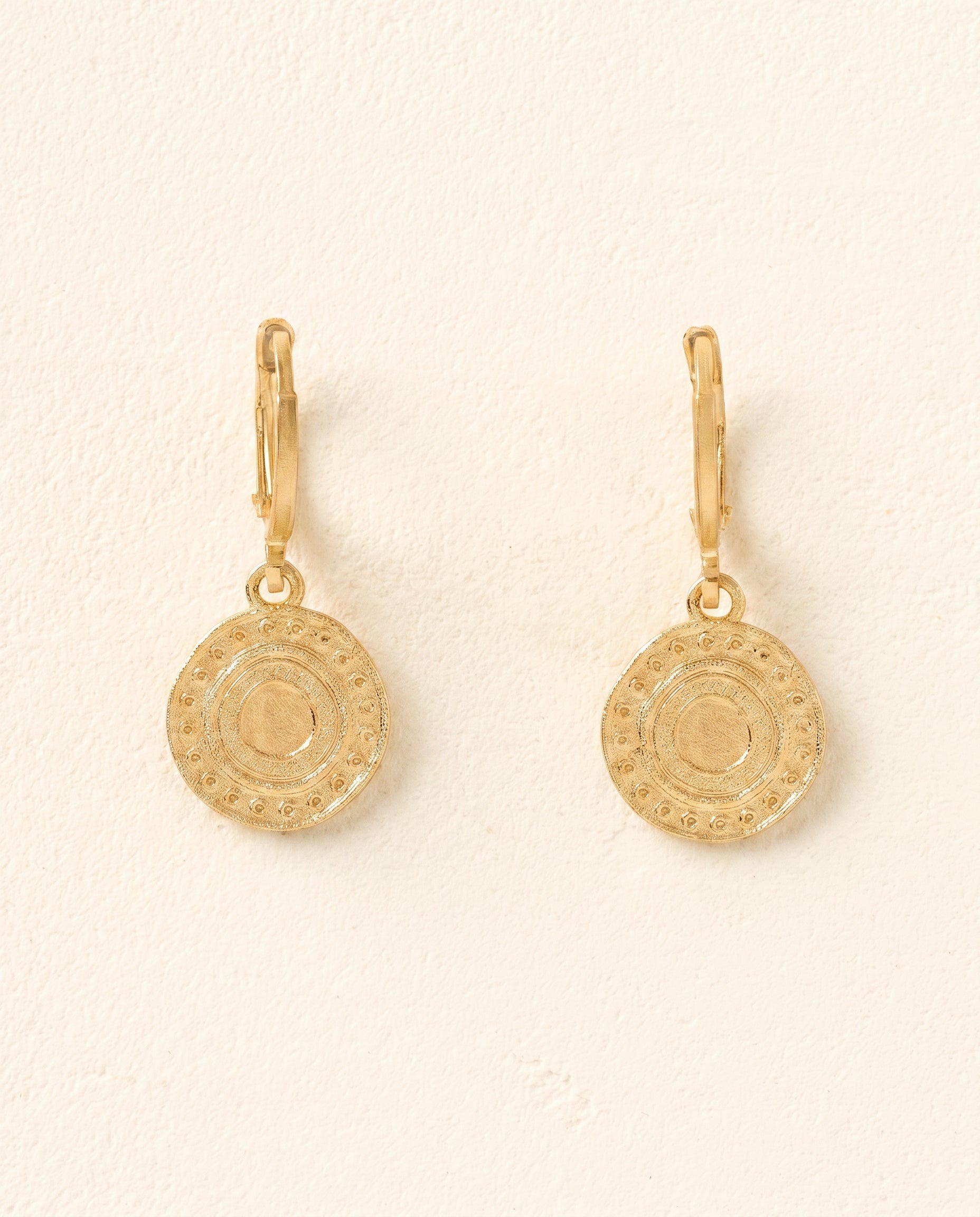 Alba gold-plated earrings with intriguing ancient Persian-inspired circular charm design.