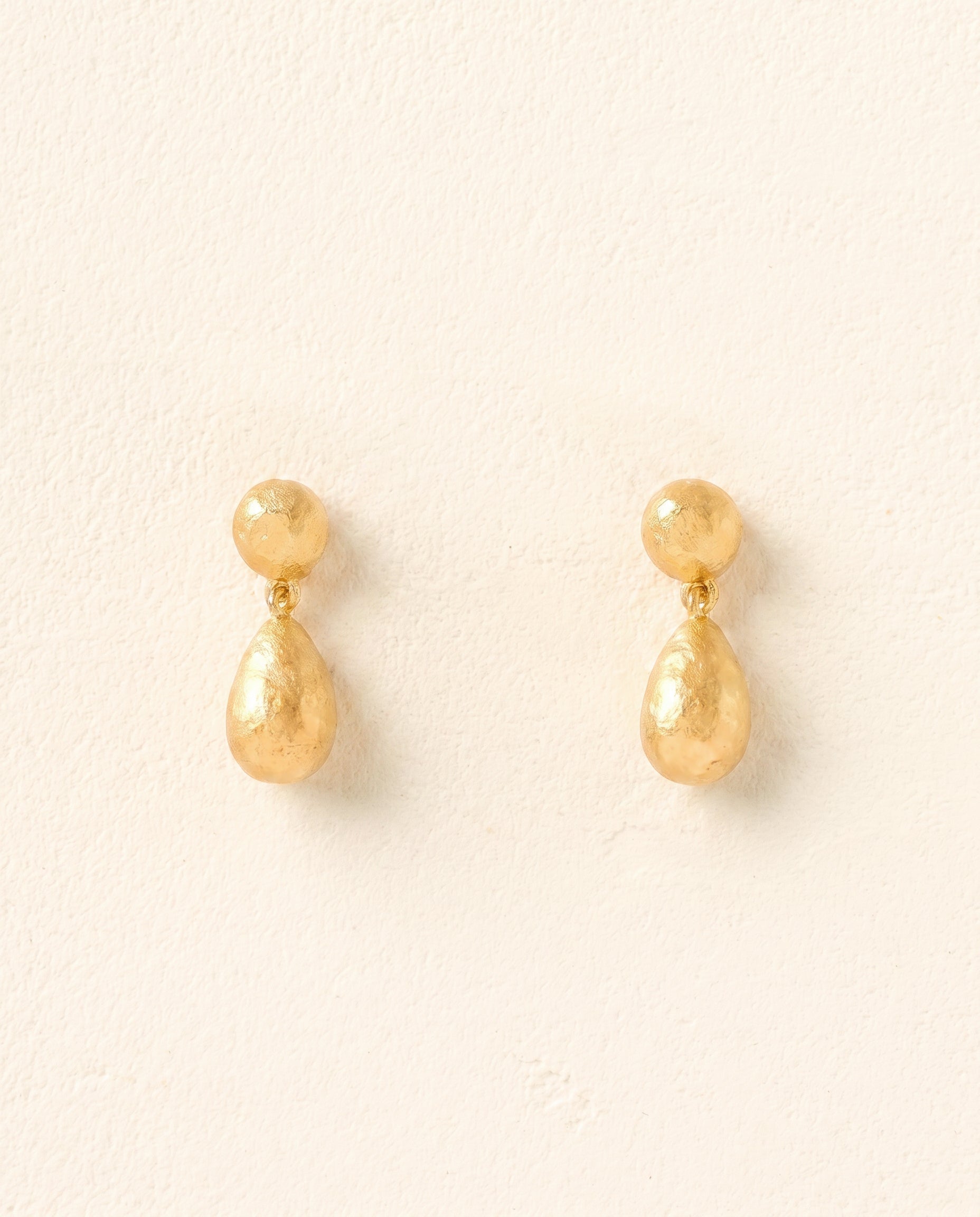 Dalias gold drop earrings with textured, organic pearl-like shapes.