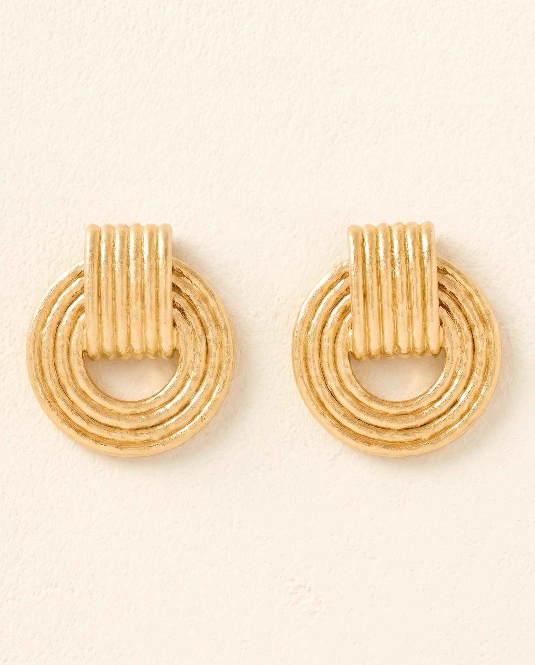 Giulia chunky gold dangling hoop earrings with a ridged, retro design.
