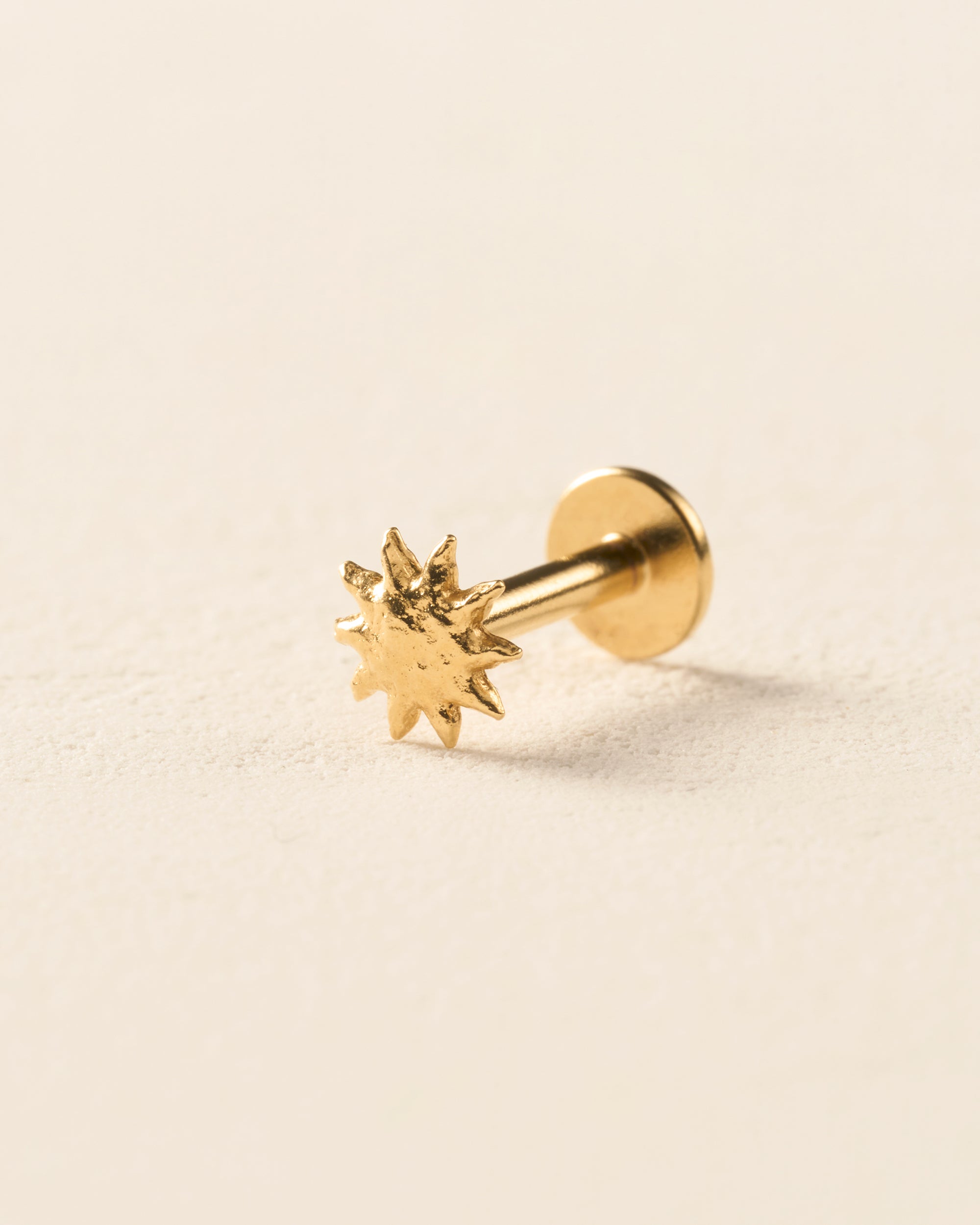 Gold Solé Piercing Stud: small, hammered sun earring with a domed surface.