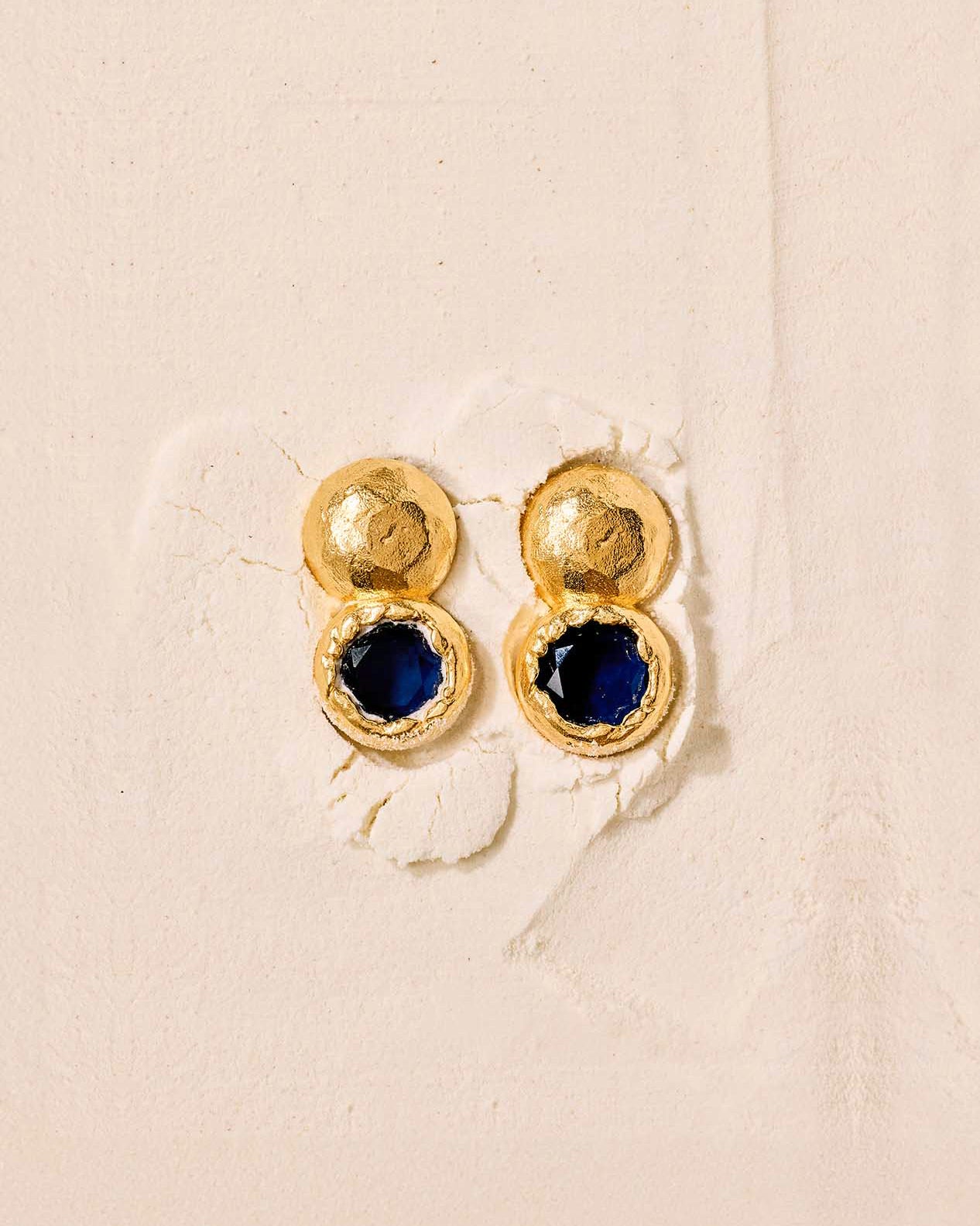 Petra earrings: hammered gold with round, deep night blue stones.