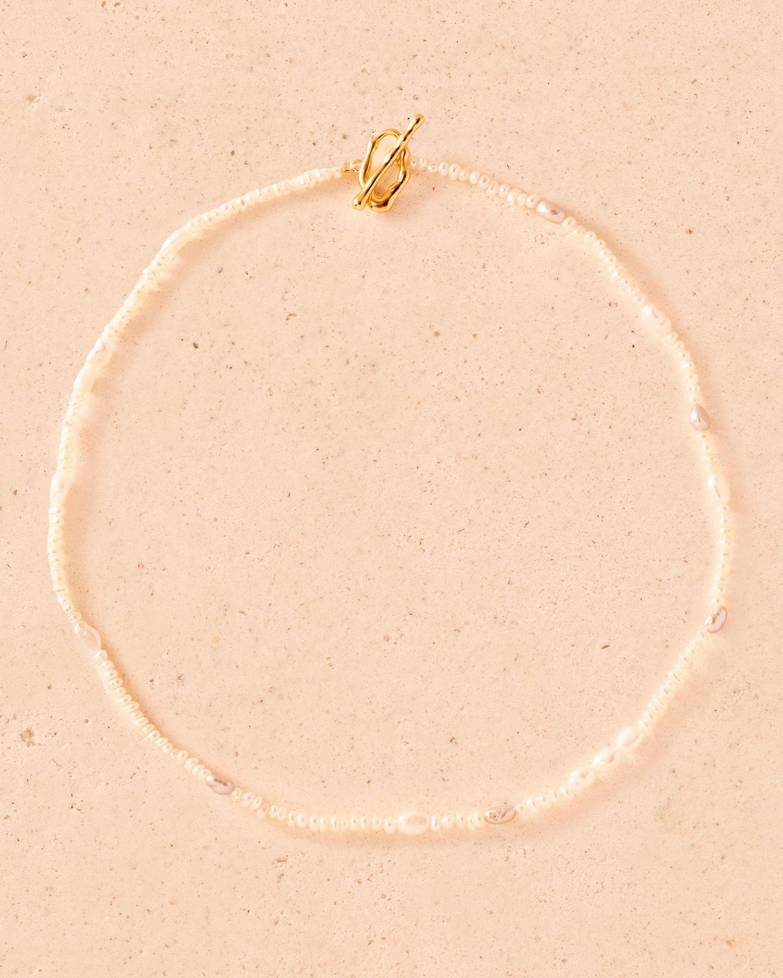 Oia Choker: Handmade necklace with delicate white and grey freshwater pearls and a gold toggle clasp.