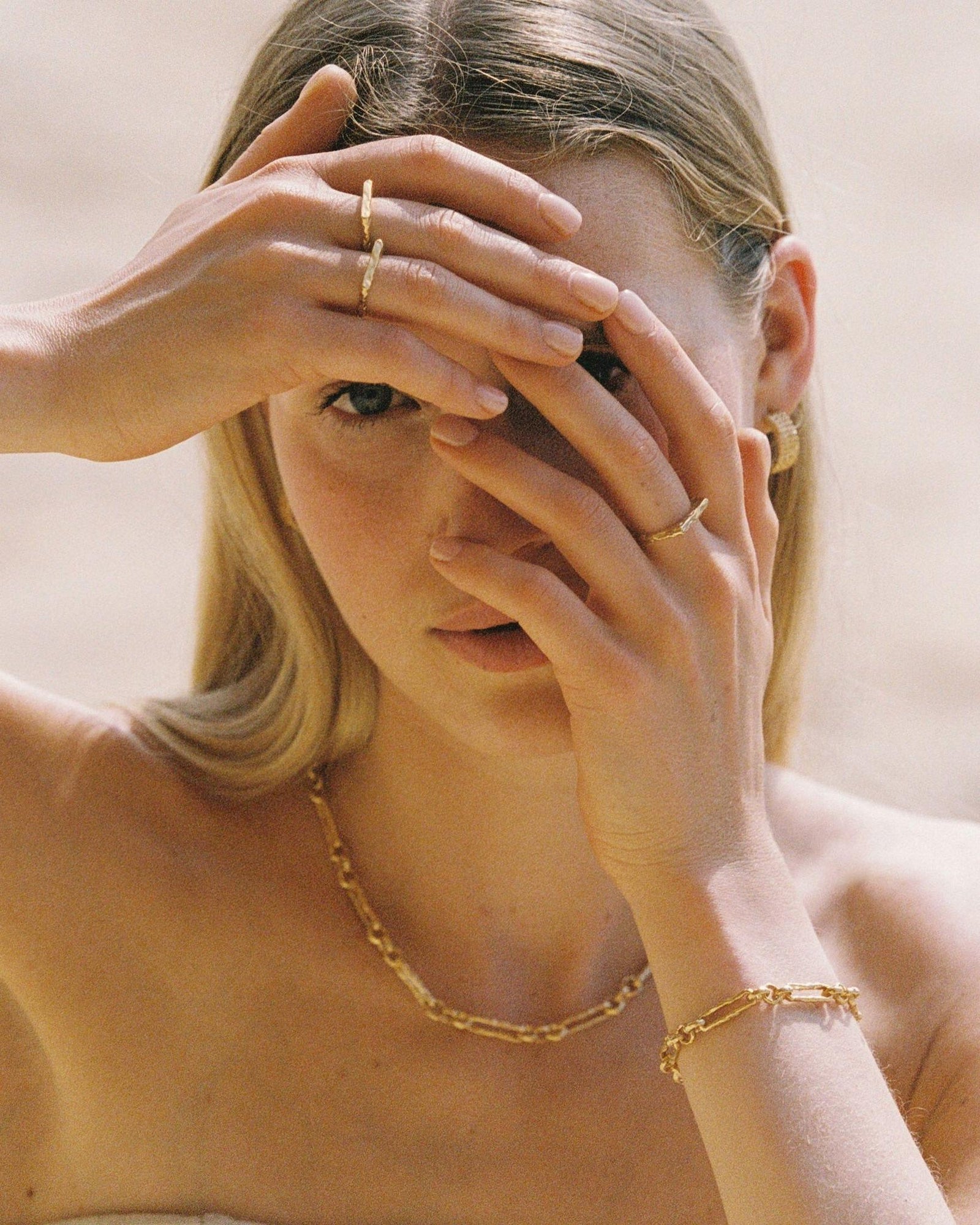 Gold Lavinia bar chain bracelet with hammered, irregular elongated and rounded links, T-bar clasp.