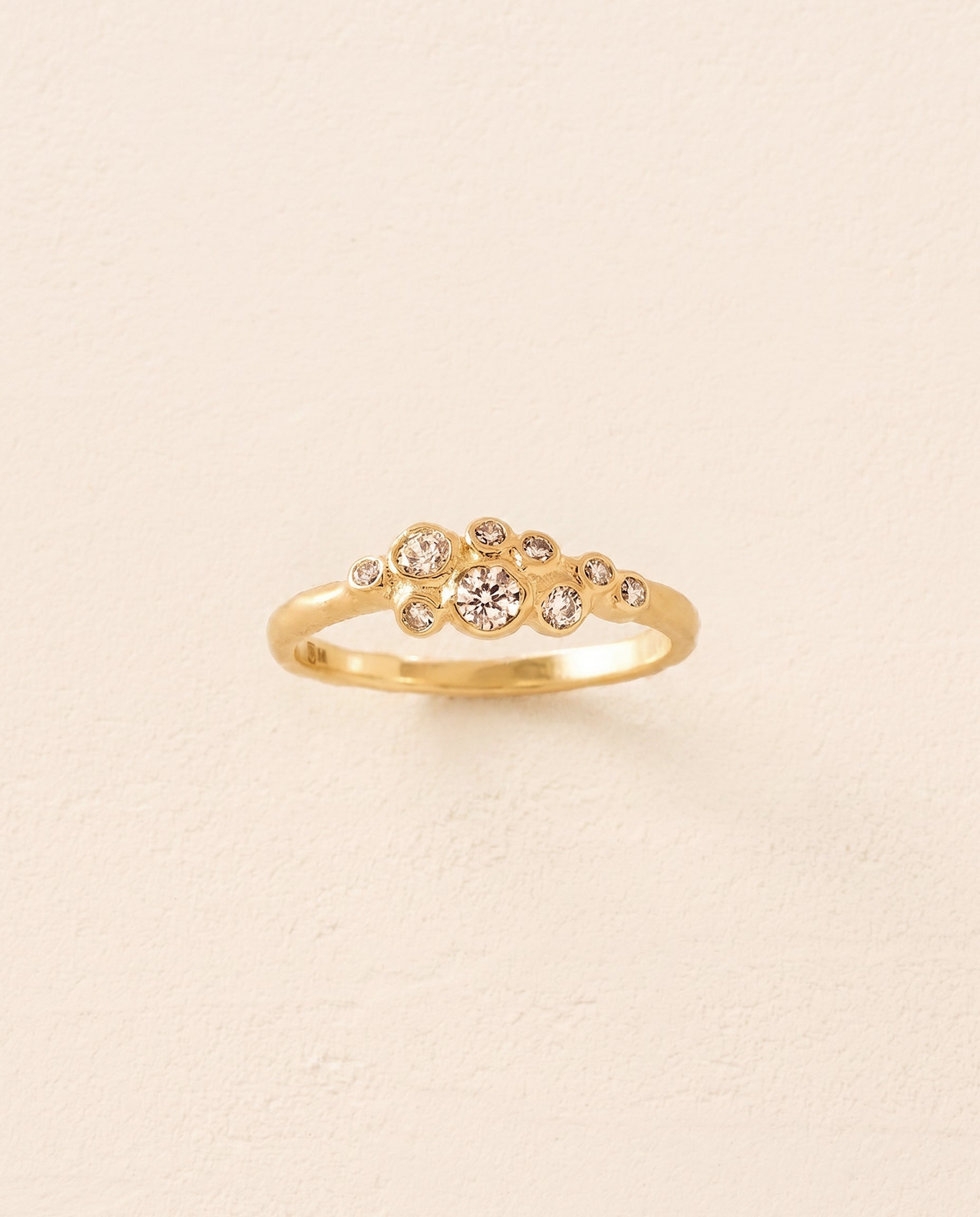 Gold Atys slim cluster ring with irregularly inlaid white stones.