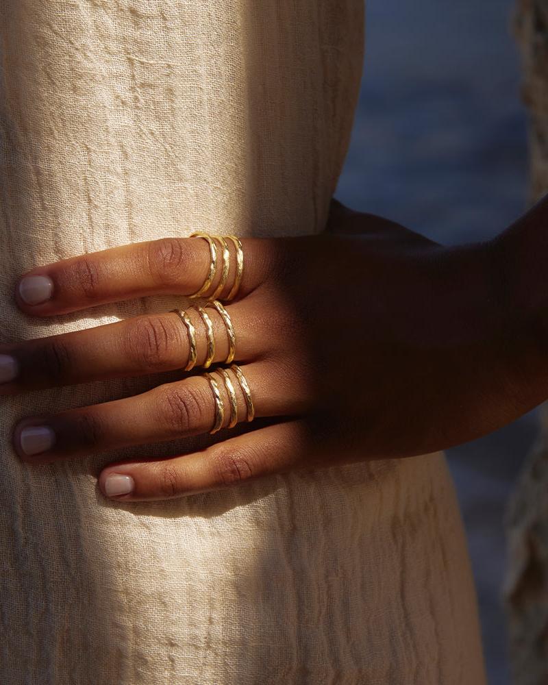 Lati Ring: Gold ring with three parallel, twisted rows linked by a vertical thread, worn on a hand.