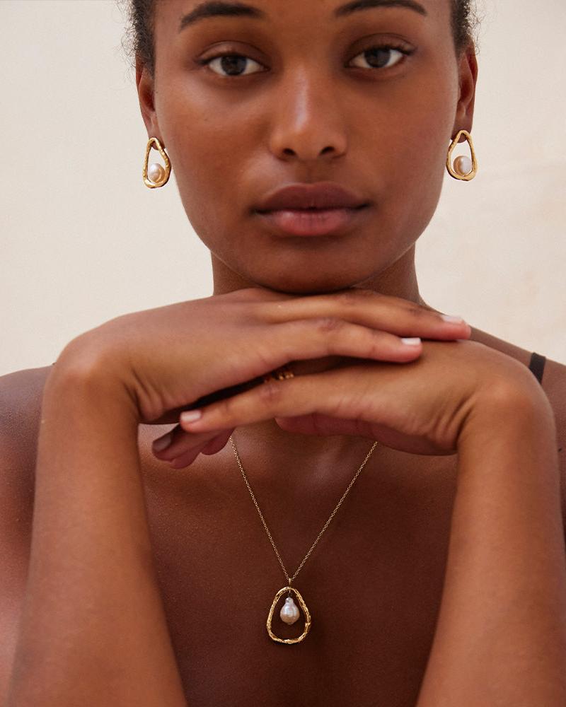 Gold Ostuni earrings and matching pendant necklace with floating mother-of-pearl.