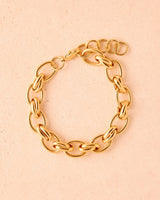 Gold chain Alessia bracelet on a beige background